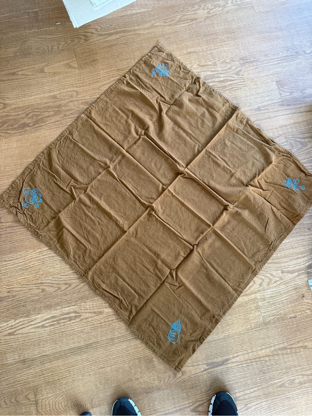Vintage handmade embroidered baby blanket with blue embroidery in each corner
